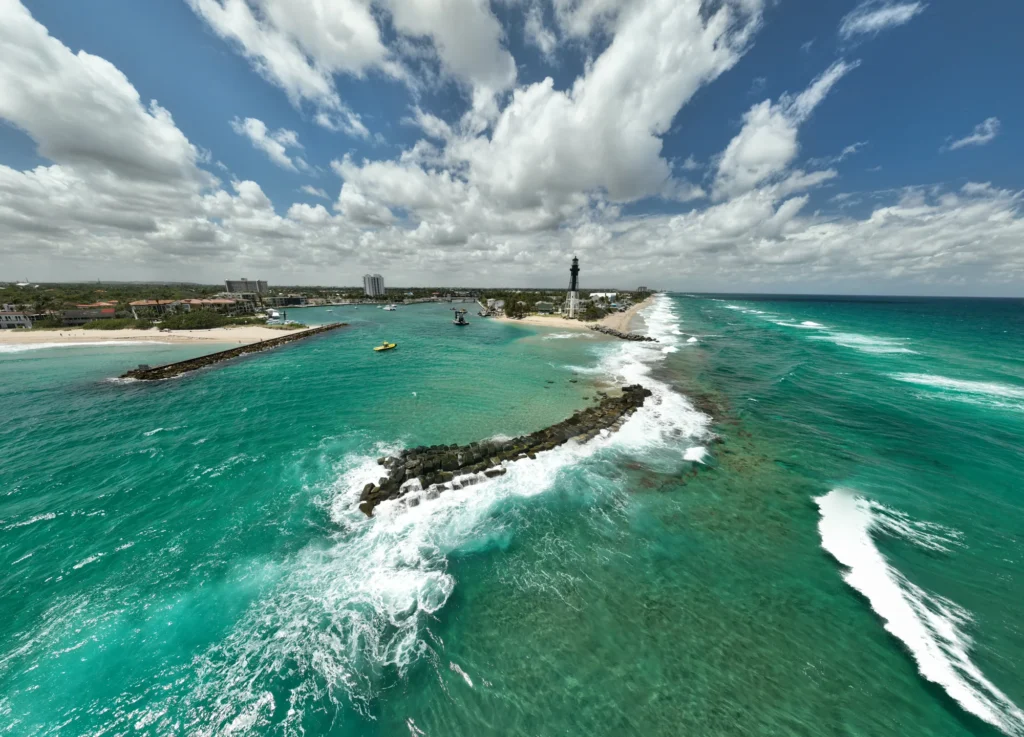 Lighthouse, waves and inlet breakwaters