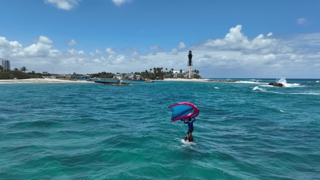 Kiteboarder with a lighthouse in the distance