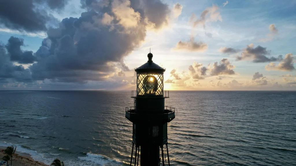 Lighthouse lantern against a dramatic coastal sky