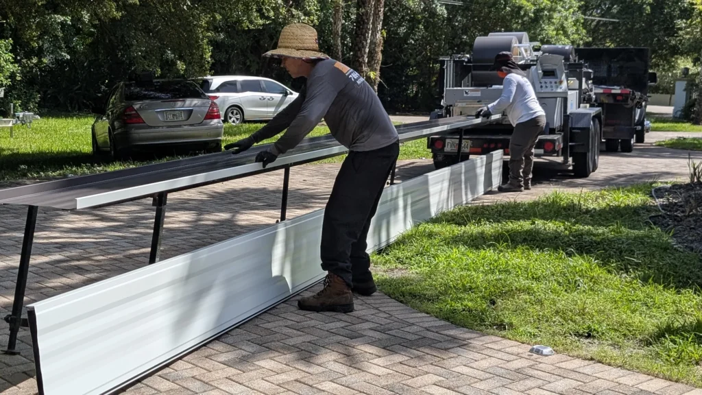 Handling a newly formed metal roof panel