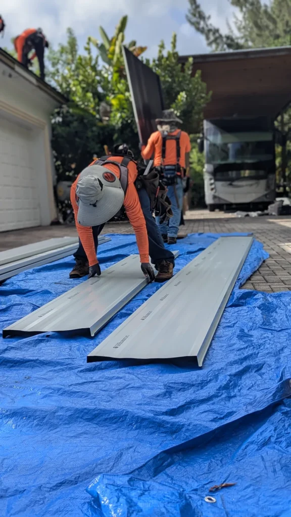 Workers preparing roof panels