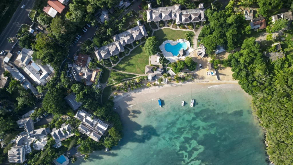 Aerial view of a coastal resort and swimming pool