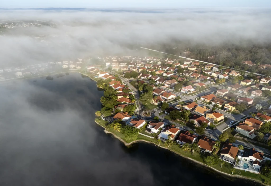 Residential waterfront beneath low cloud