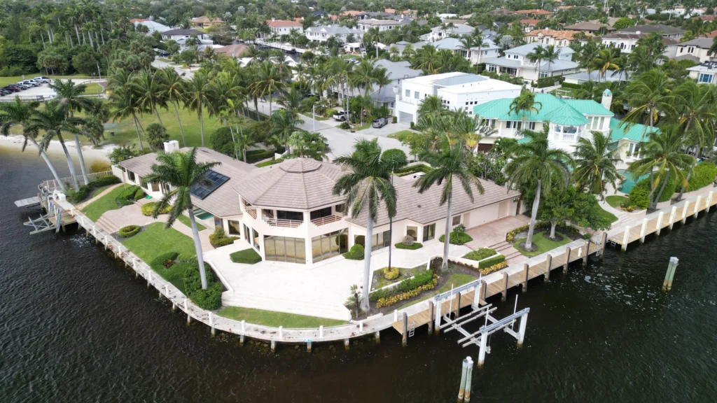 Waterfront home surrounded by palms