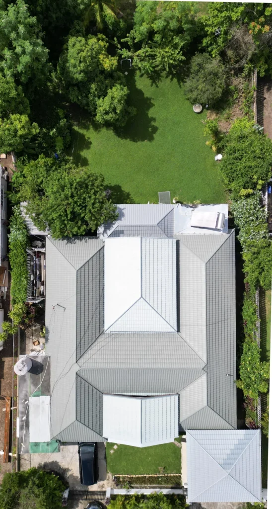 Overhead view of a roof and landscaped property