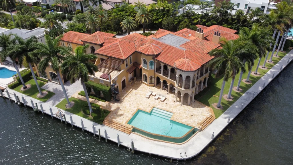 Aerial view of a waterfront home and pool