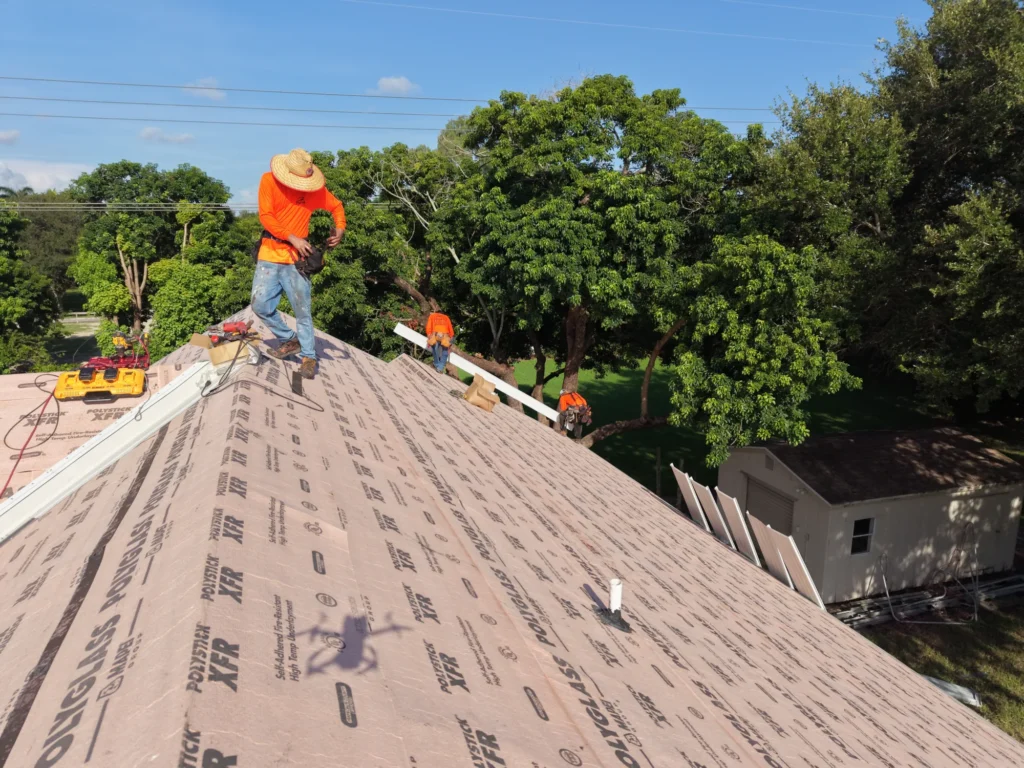 Worker at the ridge of a roof installation